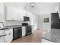 Modern kitchen featuring granite countertops, white cabinets, and stainless steel appliances at 12112 Shearwater Dr, New Port Richey, FL 34654