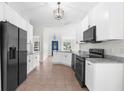 Modern kitchen with white cabinets and black appliances at 12112 Shearwater Dr, New Port Richey, FL 34654