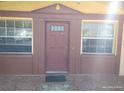 Close up of the front entrance featuring a decorative door, sidelight windows and a tile porch at 12716 Mulberry Ln, Hudson, FL 34667