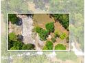 Aerial view of a property showing the foundation and lush surrounding trees at 16284 Sandusky St, Brooksville, FL 34604
