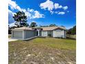 Traditional home featuring large, manicured front lawn with an attached two car garage at 2165 Bolger Ave, Spring Hill, FL 34609