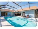 Sparkling screened-in pool and spa area, perfect for relaxation and entertaining at 2224 Sand Bay Dr, Holiday, FL 34691