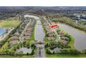 Aerial view of a neighborhood, highlighting a prime location with access to lakes and green spaces at 2330 Tarragon Ln, Trinity, FL 34655