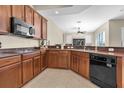 Well-equipped kitchen with tile flooring, ample counter space and cabinets for meal preparation and kitchen appliances at 2330 Tarragon Ln, New Port Richey, FL 34655