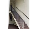 Staircase view leading to unit entrance, featuring neutral colored steps and metal railings at 2688 Pine Ridge N Way # D2, Palm Harbor, FL 34684
