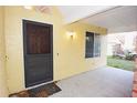 Inviting front porch featuring a textured stucco exterior, a classic front door, and a covered entryway at 29341 Rhodin Pl, Wesley Chapel, FL 33545
