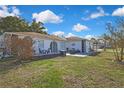 Quaint backyard featuring a patio set and well-maintained lawn for outdoor enjoyment at 4560 Lamson Ave, Spring Hill, FL 34608