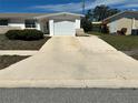 Wide driveway leading to the attached garage of a well-maintained single-story home at 5441 Mosaic Dr, Holiday, FL 34690