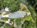 Overhead shot shows the property, boat house, patio, and waterfront on a lush green lot at 6090 Waverly Rd, Weeki Wachee, FL 34607