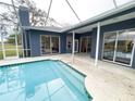 Enjoy a refreshing screened-in pool with ample patio space, perfect for outdoor entertaining and relaxation at 6393 Pinehurst Dr, Spring Hill, FL 34606