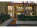 Charming condo featuring stone accents and a tiled roof, complemented by lush landscaping and a private entrance at 7650 Forest Trl # 7, Port Richey, FL 34668