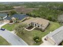 Aerial view of the house, showcasing its layout, landscaped yard and beautiful pond nearby at 8373 Maybelle Dr, Weeki Wachee, FL 34613