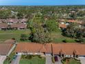 Overhead view of a residential community with lush green spaces, mature trees, and well-maintained homes at 9713 Sweeping View Dr, New Port Richey, FL 34655