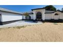 Beautiful single-story home with modern architectural details and a fresh white exterior at 1032 Concert Ave, Spring Hill, FL 34609
