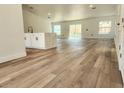 Open-concept living area with hardwood floors, recessed lighting, and access to the backyard through sliding glass doors at 1032 Concert Ave, Spring Hill, FL 34609