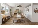 Well-lit dining room with hardwood floors, ceiling fan and stylishly decorated table at 10841 Scenic Dr, Port Richey, FL 34668