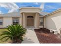 Inviting front entrance with elegant columns and manicured landscaping at 13140 Maycrest Ave, Weeki Wachee, FL 34614