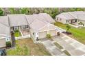 Expansive aerial view of a single-story home featuring a two-car garage, and a well-maintained lawn with a patio at 13227 Molitor Ct, Hudson, FL 34669