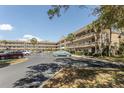 Spacious condominium building showcasing well-maintained exteriors and ample parking with lush tropical landscaping at 2464 Australia E Way # 46, Clearwater, FL 33763