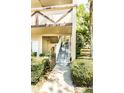 Exterior view of a condo stairway showing the entrance and well-maintained landscaping at 2464 Australia E Way # 46, Clearwater, FL 33763