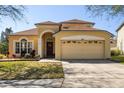 Charming two-story home with a manicured front yard and attached two-car garage at 3042 Gianna Way, Land O Lakes, FL 34638