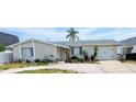 Single-story home features a stone facade, attached garage, and well-maintained landscaping at 4030 Grayton Dr, New Port Richey, FL 34652