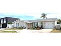 Beautiful single-story home with stone facade, attached garage, and manicured landscaping at 4030 Grayton Dr, New Port Richey, FL 34652