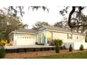 Charming single-story home with a blue door, well-manicured lawn, and welcoming curb appeal at 513 Meres Blvd, Tarpon Springs, FL 34689
