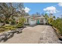 Charming single-story home with a well-manicured lawn, long driveway, and inviting curb appeal at 513 Meres Blvd, Tarpon Springs, FL 34689
