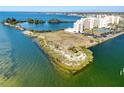 Waterfront condo building surrounded by picturesque bay waters, a peninsula, and nearby amenities at 5915 Sea Ranch Dr # 211, Hudson, FL 34667