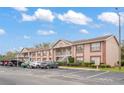 Exterior of condo building with guest parking, covered parking, and well-maintained landscaping at 6440 Spring Flower Dr # 11, New Port Richey, FL 34653