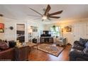 Spacious living room with hardwood floors, comfortable seating, and large ceiling fan at 6710 Devonshire Ln # 10A, New Port Richey, FL 34653