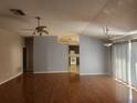Spacious living room with hardwood floors, an open floor plan, and plenty of natural light at 7125 Silverwood Dr, New Port Richey, FL 34654