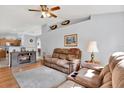 Inviting living room features a fireplace, ceiling fan, and neutral wall color scheme at 7205 Pinehurst Dr, Spring Hill, FL 34606