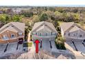 Aerial image of a townhome in a neighborhood surrounded by mature trees and well manicured landscaping at 7624 Red Mill Cir, New Port Richey, FL 34653
