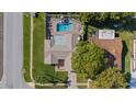 Aerial view of a home with a private backyard pool and patio area at 7901 Willow Brook Ct, Hudson, FL 34667