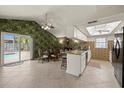 Open-concept kitchen and dining area with stone accents, access to the pool, and ample natural light at 7901 Willow Brook Ct, Hudson, FL 34667