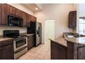 Well-equipped kitchen featuring stainless steel appliances, granite countertops, and dark cabinetry at 10056 Lebanon Dr, Port Charlotte, FL 33981