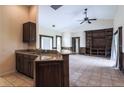 Open floor plan with tile flooring, built-in shelving, and a kitchen bar, perfect for entertaining at 10056 Lebanon Dr, Port Charlotte, FL 33981