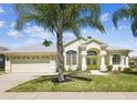 Charming one story home with a three car garage and manicured front lawn at 10285 Velvetseed Cir, Spring Hill, FL 34608