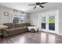 Cozy living room with comfortable seating, modern flooring, and access to the outdoor space at 1283 Coble Rd, Spring Hill, FL 34608