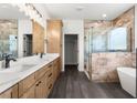 Spacious bathroom with double vanity, marble countertops, frameless shower, and freestanding tub at 16043 Penn State Rd, Weeki Wachee, FL 34614
