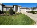 Well-maintained single-story home with a lush lawn and neat landscaping at 18045 Tarrington Pl, Hudson, FL 34667