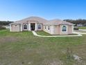 Charming single-story home with a well-manicured lawn and inviting entrance, located on a spacious corner lot at 18317 Treehaven Dr, Hudson, FL 34667