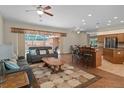 Spacious living room featuring modern furniture, bar seating, and an open floor plan at 19263 Quiet Oak Ln, Brooksville, FL 34604