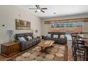 Open living room featuring tile flooring, ceiling fan, comfortable seating, and a view of the pool at 19263 Quiet Oak Ln, Brooksville, FL 34604