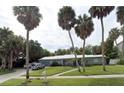 A nicely landscaped home with palm trees, a well-kept lawn, and an attached two-car garage at 2606 S Hawthorne Cir, Tampa, FL 33629