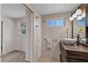 Updated bathroom with stylish vanity, decorative mirror, and neutral tile at 3728 Linkwood St, New Port Richey, FL 34652