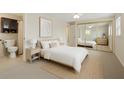 Bright bedroom featuring a large bed, mirrored closet, and en-suite bathroom at 3728 Linkwood St, New Port Richey, FL 34652