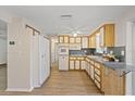 Bright kitchen featuring ample cabinet space, modern appliances, and laminate floors at 3728 Linkwood St, New Port Richey, FL 34652